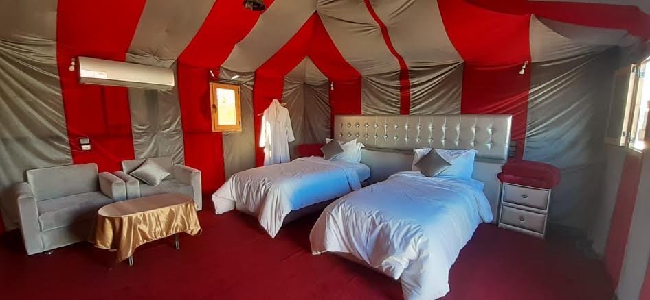Tienda de campamento en el desierto de Erg Chebbi, con dos camas y aire acondicionado.